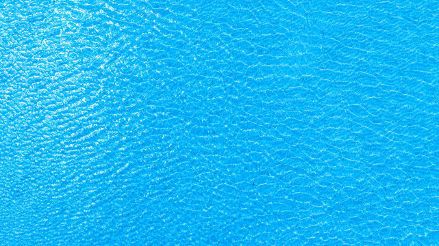 Top view of deep blue sea water surface with small ripples, aerial drone shot of turquoise ocean texture at island , abstract nature background	
