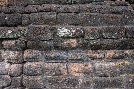 The laterite stone wall in Sukhothai historical park, Thailand. Sukhothai's brick structures, many of the temples here were built with laterite stone.