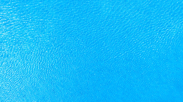 Top view of deep blue sea water surface with small ripples, aerial drone shot of turquoise ocean texture at island , abstract nature background	