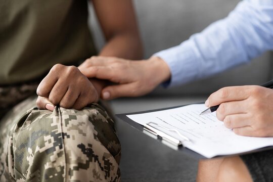 Concerned Black Female Soldier Receiving Emotional Support And Counseling At Office From Professional. Setting A Tone Of Care And Understanding In A Healthcare Concept.