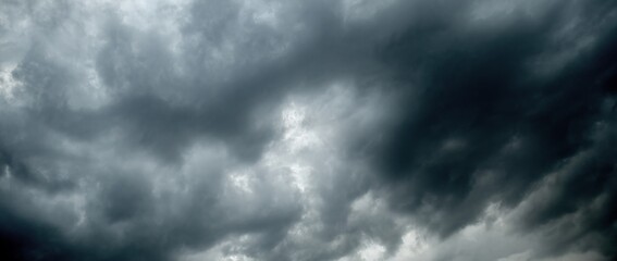 Fototapeta premium dark clouds sky black Heavy rain thunderstorm. Pattern clouds overcast tornado Hurricane cyclone typhoon storm and rainy. Dark sky cloudy have storm lightning thunderbolt. Dark Dramatic Clouds