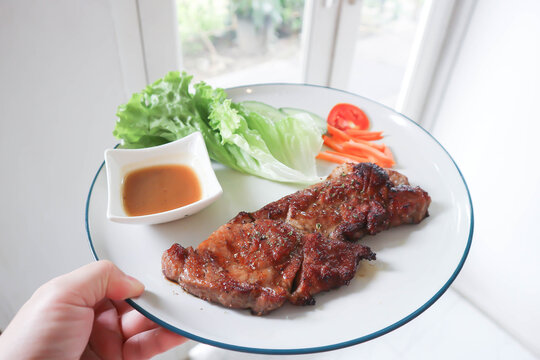 pork steak or grilled pork and salad or pork chop and vegetable