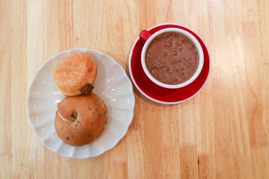 bread, bun or cranberry bread or cranberry bun or cranberry bagel and donut or doughnut with hot cocoa
