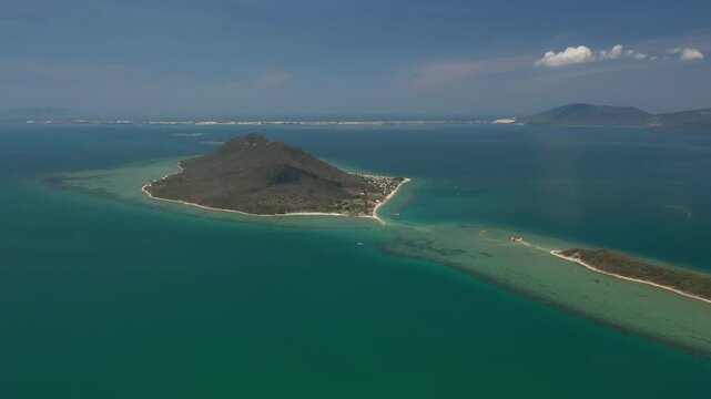 Aerial view of Diep Son Islands in Van Phong Bay, Van Thang Commune, Khanh Hoa, Vietnam, with a kayaker paddling through crystal-clear turquoise waters and scenic coastal landscapes.