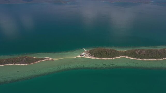 Aerial view of Diep Son Islands in Van Phong Bay, Van Thang Commune, Khanh Hoa, Vietnam, with a kayaker paddling through crystal-clear turquoise waters and scenic coastal landscapes.