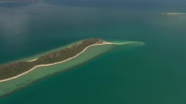 Aerial view of Diep Son Islands in Van Phong Bay, Van Thang Commune, Khanh Hoa, Vietnam, with a kayaker paddling through crystal-clear turquoise waters and scenic coastal landscapes.