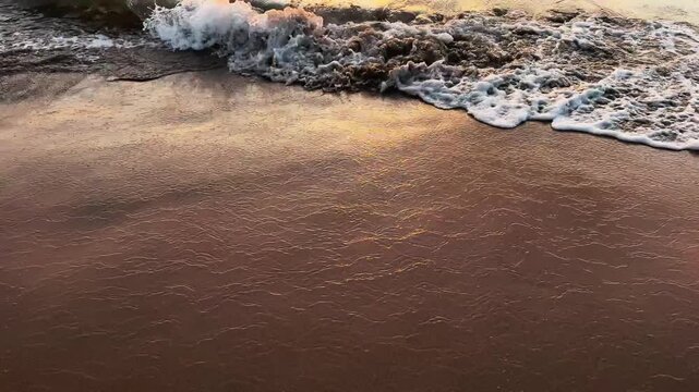 Slow motion 120fps Close Up of Gentle Foamy Wave Edge on Tropical Beach Sand