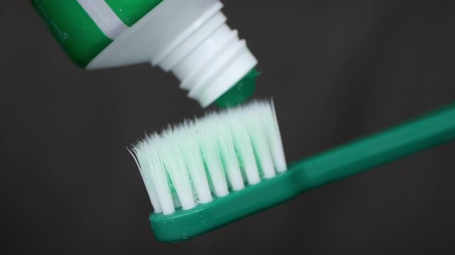 Brushing teeth with green toothpaste