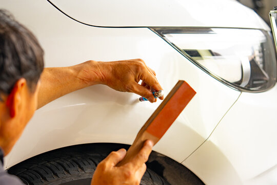 Removing dents on the car. PDR technology. Car body repair without painting.