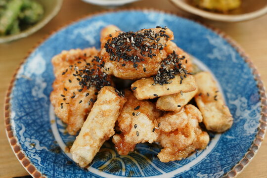 Japanese sweet and savory braised chicken with burdock root (Amakara Tori Gobo) in a ceramic bowl - 日本料理 甘辛鶏ごぼう 和食惣菜