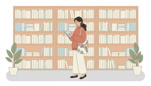 Young female student standing in front of large bookshelves and reading a book with interest in a library or bookshop.