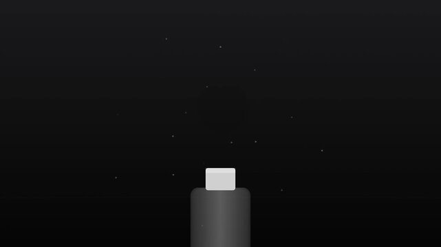 A small light gray cube sitting upon a dark cylindrical post surrounded by tiny particles floating in the air representing a scientific experiment about gravity and physics within a dark chamber