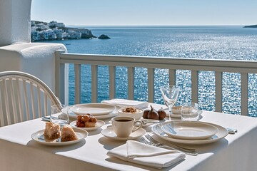 Naklejka premium Breakfast table set with food and drinks overlooking