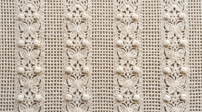 Intricate crochet textile with delicate butterfly motifs and raised bobble details in soft natural light
