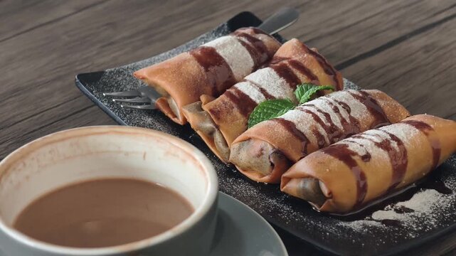 crispy rolled chocolate banana dish and mocha coffee on the table