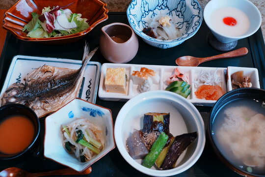 Traditional Japanese Ryokan breakfast set with side dishes, grilled fish, and rice 