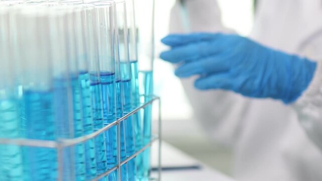 Close-up video of test tubes, scientists in a laboratory doing experiments, scientists who are researchers in a laboratory are analyzing.