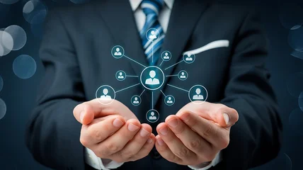 A businessman in a suit holding an abstract network of people in his hands, symbolizing connection and organization © Mst Rozina Pervin