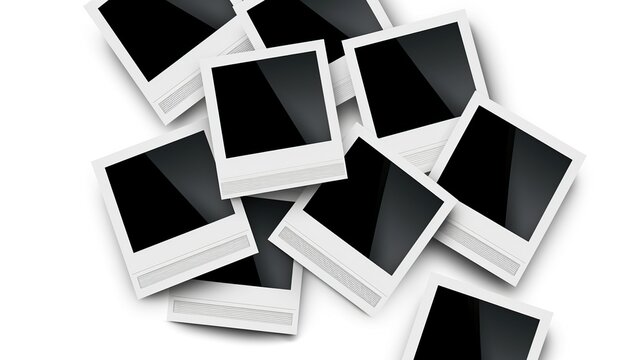 A chaotic assortment of blank Polaroid photographs scattered haphazardly in a pile