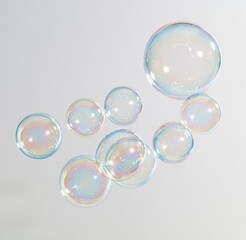 Obraz premium Colorful iridescent soap bubbles floating against white background