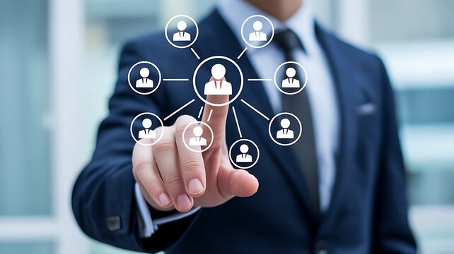 A businessman in a suit touching a digital interface showing a network of people connected to a central figure. The concept of networking and team building is highlighted