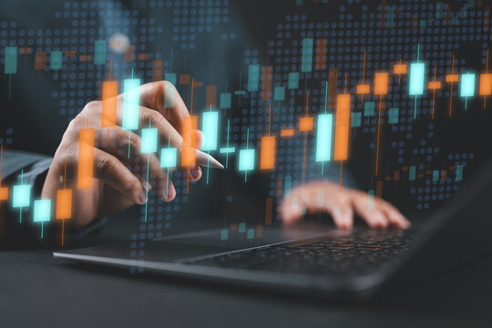 Stock market price charts and global market graphs. Financial trading data. Foreign exchange and commodities. Trader using a laptop computer to invest in various financial products.