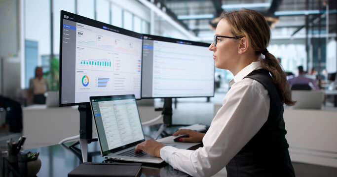 Young Woman Using Laptop To Analyze Business Data