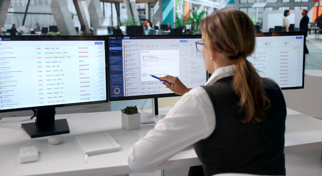 Young Woman Working Quickly On Help Desk Tickets