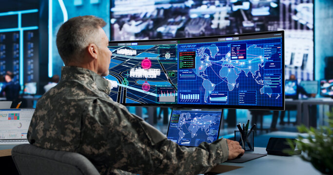 Commander Uses Computer And World Map