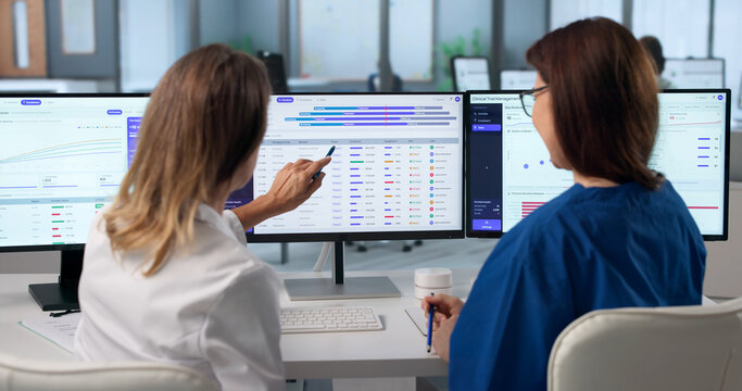 Woman In Medical Uniform Analyzes Patient Enrollment Data