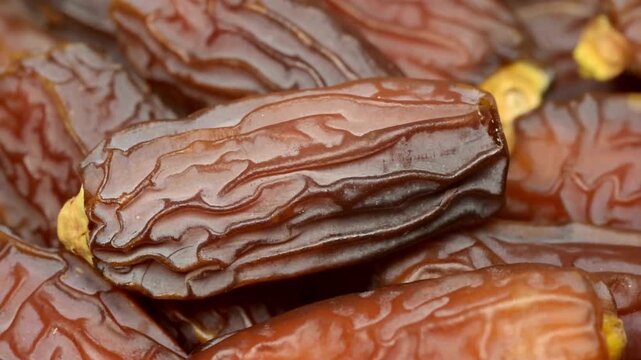 Organic dried dates fruit macro, sweet medjool dates texture close up, brown wrinkled date palm fruits for ramadan and healthy snacking