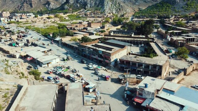 Aerial view of Landi Kotal settlement and rugged mountains in Khyber, Pakistan
Drone view of Landi Kotal valley with mountain landscape and dry riverbed
Landi Kotal village and mountain valley viewed 