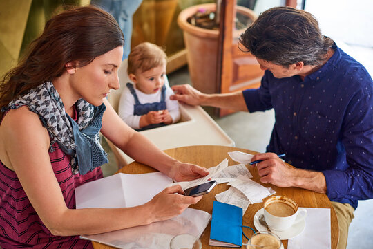 Small business, couple and phone at cafe with bills, research and daily sales for monthly expenses. Above, family and mobile at coffee shop with receipts, comparing cost and finance budget of revenue