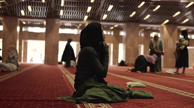 Muslim woman praying inside a grand mosque