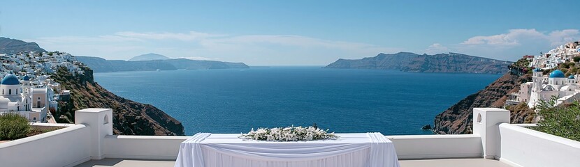 Naklejka premium White draped table with flowers overlooking caldera