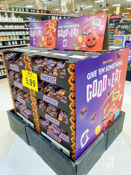 Milton USA - August,18 2026: Halloween candy display stand featuring Snickers and Mars fun size chocolates in a grocery store.
