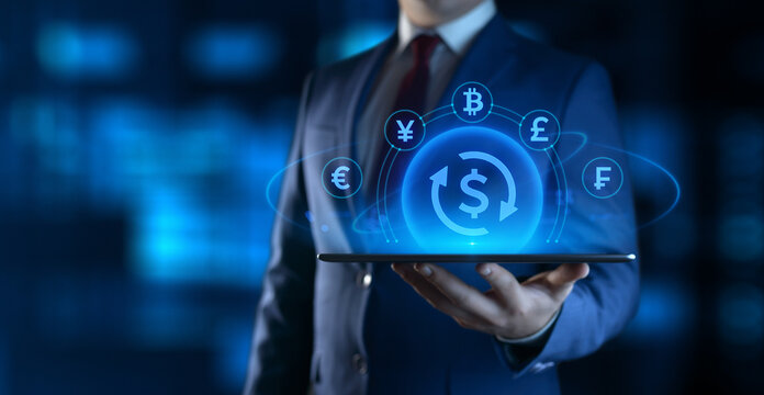 Businessman holding tablet with Currency Exchange icons on screen. Business and Finance concept
