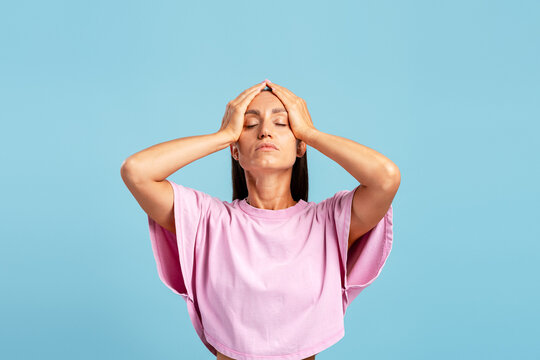 Woman having headache holding head experiencing pain