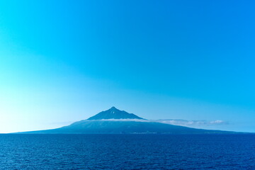 Fototapeta premium Mount Rishiri rising from the sea under clear blue sky Hokkaido Japan
