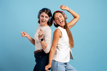 Fototapeta premium Happy young women enjoying music and dancing