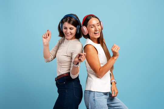 Women wearing headphones enjoying music and dancing