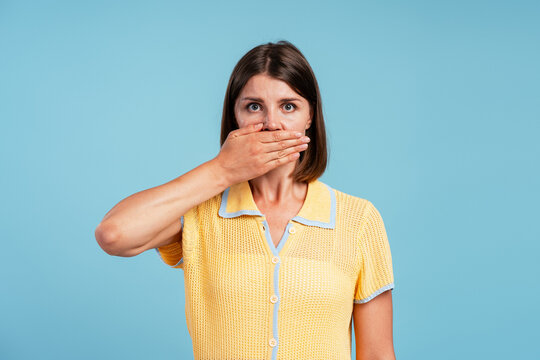Woman covering mouth showing surprise and silence concept