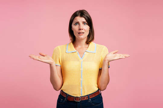 Woman shrugging hands out showing confusion and doubt