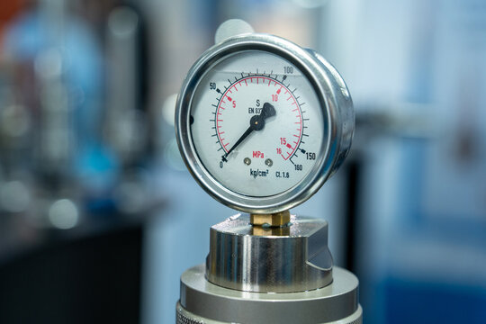 Pressure gauge installed on industrial equipment in a laboratory setting