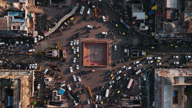 Aerial top down view of city traffic moving around a historic square in jaipur, india
