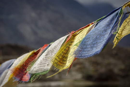 Tibetan prayer flags Lungta with blurred mountain background in Nubra Valley