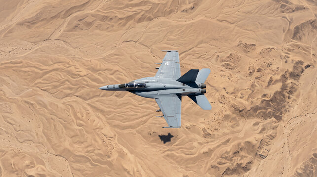 FA18 Hornet Fighter Jet Flying Over Arid Desert Landscape