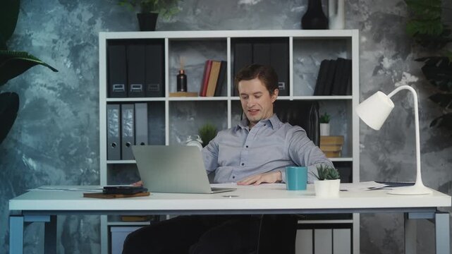 Successful young businessman throws papers in air, celebrating business victory