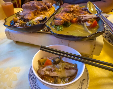 Freshly roasted Peking duck with Peking sauce with chopsticks and a traditional Chinese bowl at the Chinese restaurant.