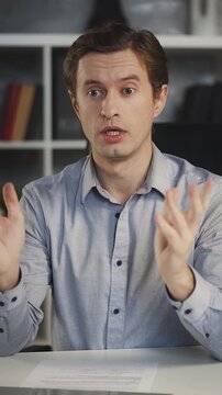 Young businessman has online video conference on laptop, working in office